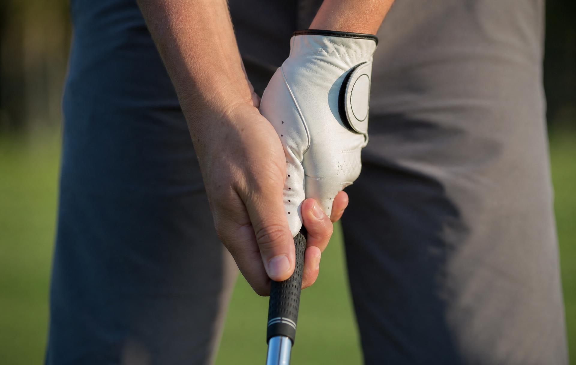 Hands forming a neutral overlap grip on a golf club