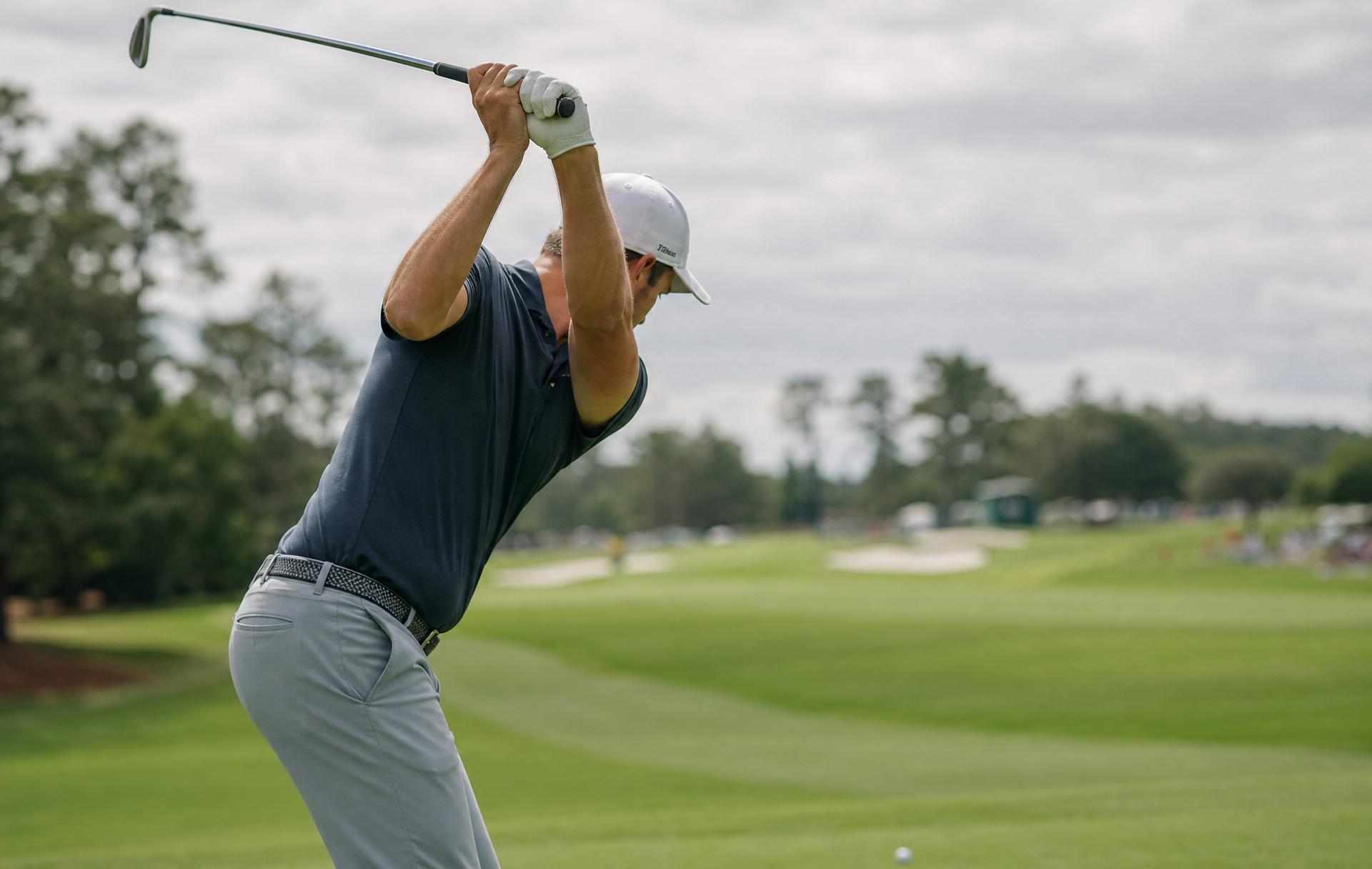 Golfer at the top of the backswing showing full shoulder turn and an extended lead arm