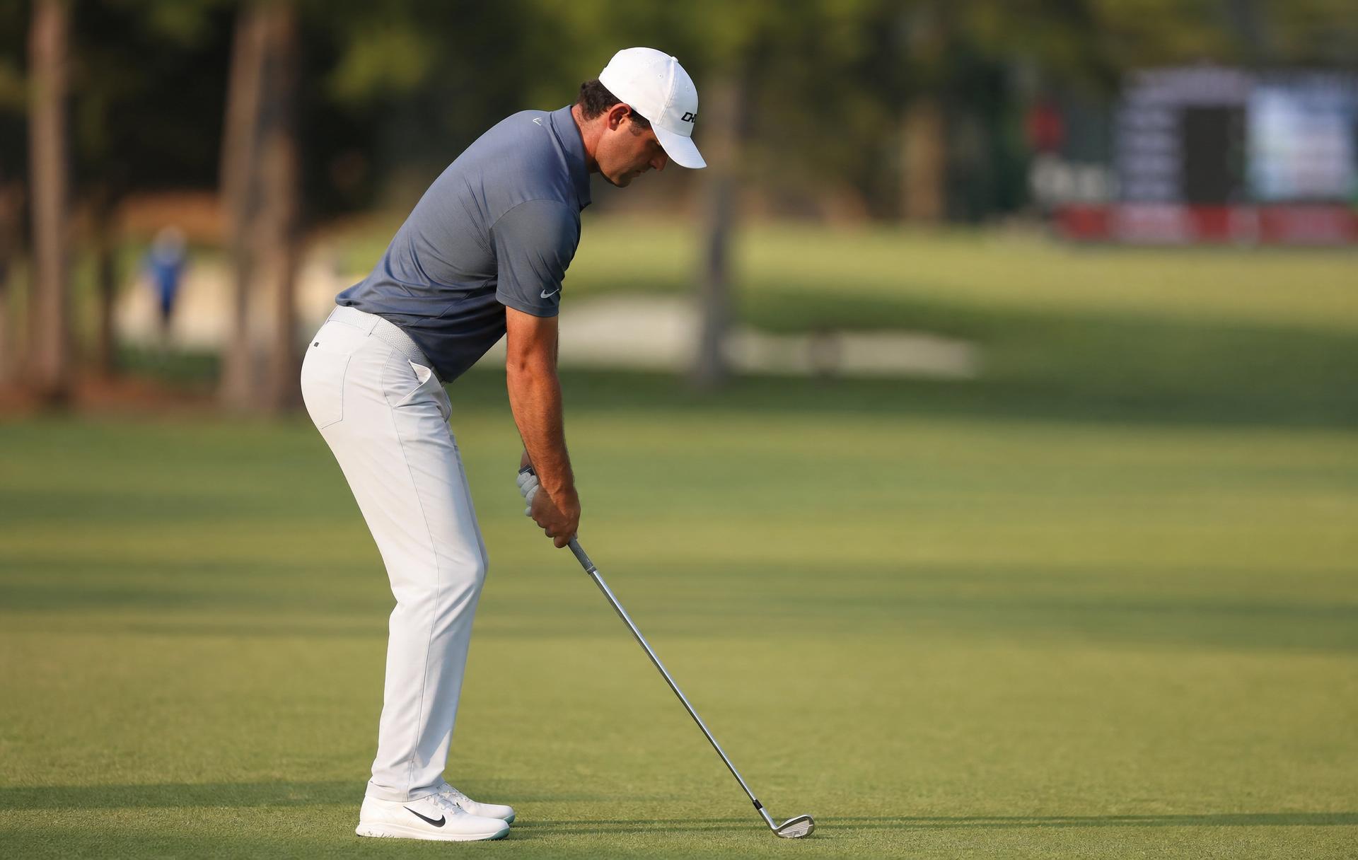 Down-the-line view of an athletic golf posture with hip hinge and spine angle at address